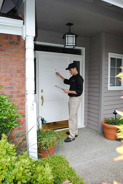 Pest Control Technician knocking on door